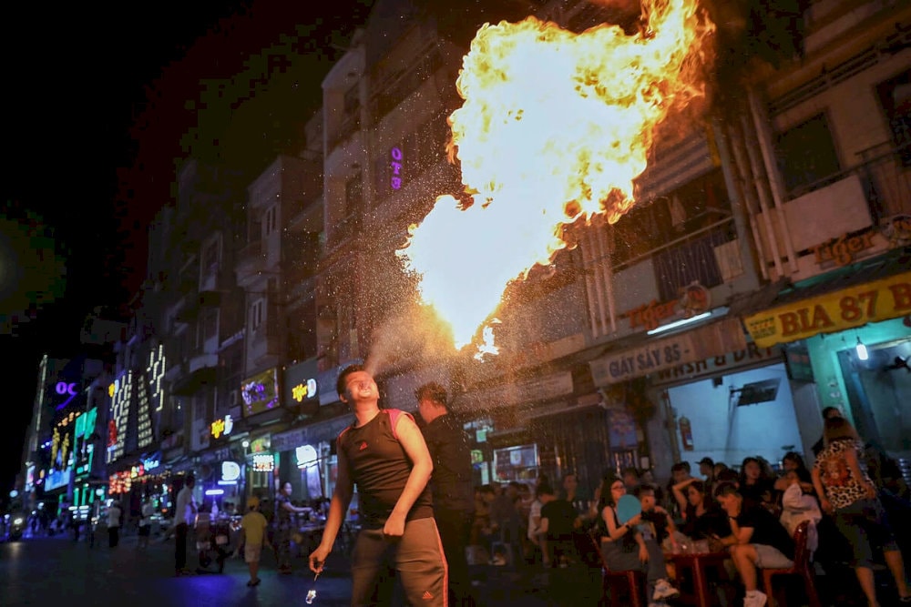 Experience the thrill of fire dancers street magicians turning Bui Vien into a stage of wonders